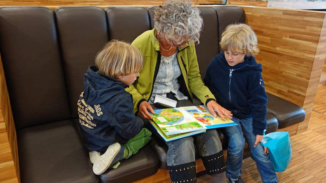 Adult reading to children.